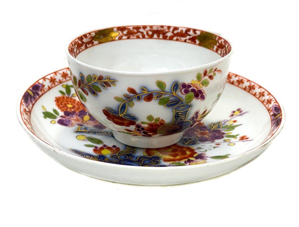 Meissen Porcelain Cup and Saucer.: An attractive Meissen Tischenmuster tea cup and saucer. Hand painted florals the central area of the cup and to the center of the saucer. Meissen marks to the underside, circa 1735. Weight Approx., 0.