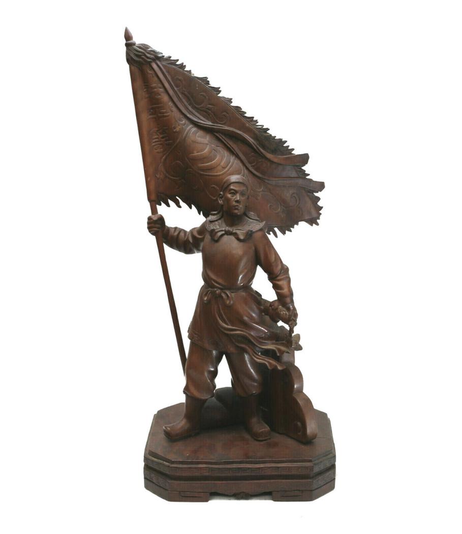 Japanese Meiji Period Samurai Wood Sculpture: Japanese Meiji period samurai wooden sculpture. The figure depicts a samurai warrior holding a flag in a commanding stance. Unmarked. Weight Approx., 5 lbs Measures Approx., 6.25 inches x 7.5 inches x
