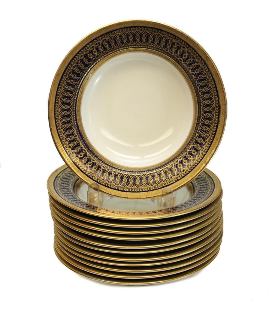 12 Cauldon for Tiffany & Co. Rimmed Soup Bowls: 12 Cauldon England porcelain for Tiffany & Co. rimmed soup bowls, circa 1900. Cobalt blue ground to the rim with gilt florals and overlapping rings throughout the edge. Marked "Cauldon England" to the