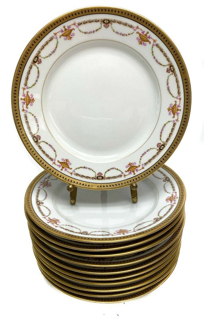 11 Bernardaud Limoges Porcelain Gilt Rim Dessert Plates: 11 Bernardaud Limoges Porcelain Gilt Rimmed Dessert Plates with Floral Swags c1910. Floral gilt swag decorations with a white ground. Weight Approx., 5.5 lbs Measures Approx., 7.2 in. diameter x 0.9 i