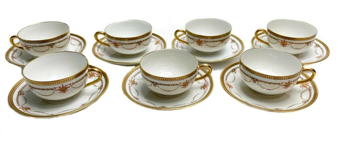 7 Bernardaud Limoges Porcelain Cups & Saucers with: 7 Bernardaud Limoges Porcelain Gilt Tea Cups & Saucers with Floral Swags c1910. Gilt design around rim and floral swag decorations throughout. Weight Approx., 3.5 lbs Measures Approx., Tea cup: 4.5 in