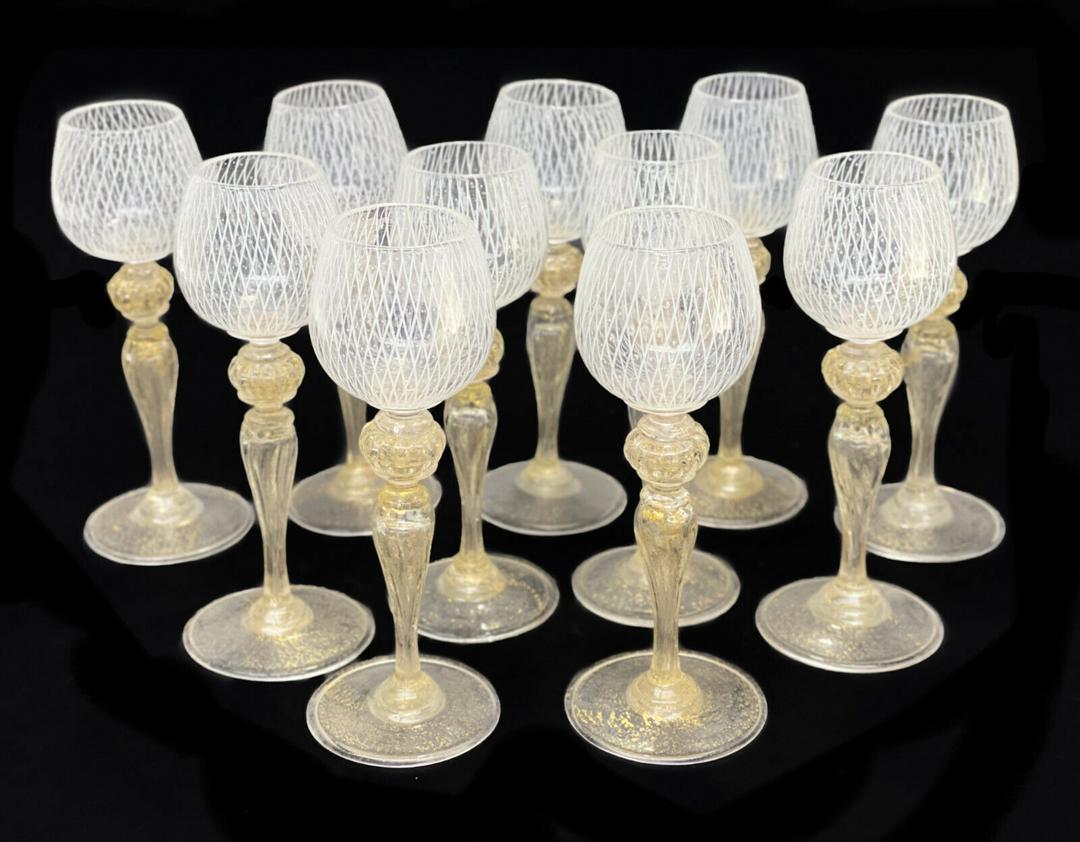 11 Venetian White Latticino Striped Aperitief Wine: 11 Venetian white latticino striped aperitief wine goblets, circa 1960. White latticino stripes to the bowls of the goblets. Gold fleck to the bulbous stems and bases. Weight Approx., 2 lbs Measures A