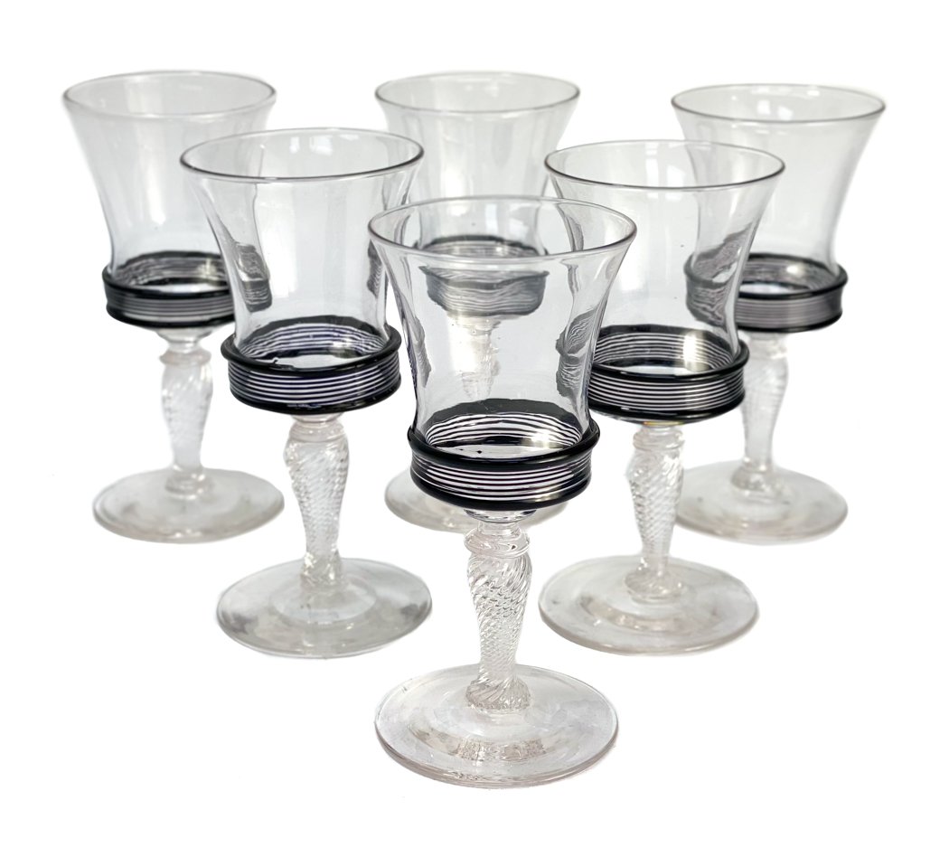 6 Steuben Cut Glass and Black Threaded Wine Goblets: 6 Steuben cut glass and black threaded wine goblets. Black threaded design to towards the base of the bowl. With a swirled texture to the baluster stem. Unmarked Weight Approx., 1.5 lbs Measures Appro