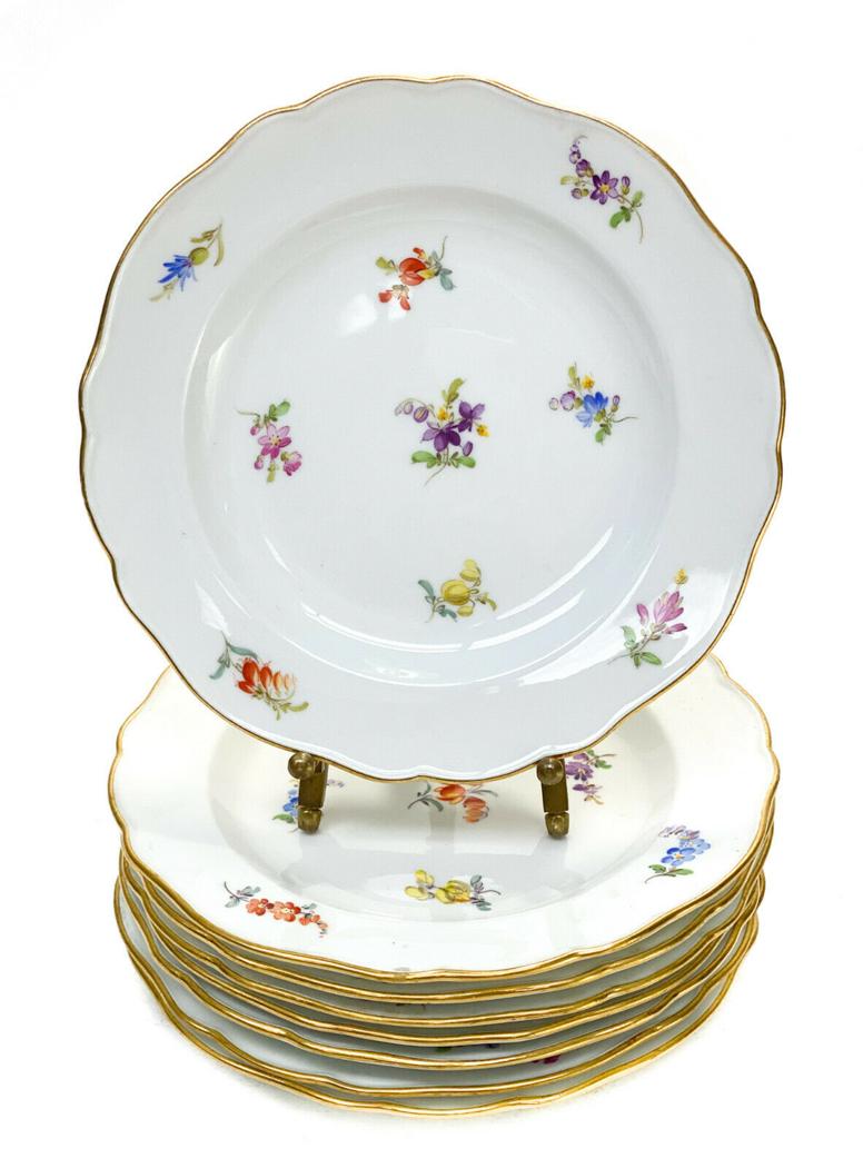 8 Meissen Porcelain Bread and Butter Plates: 8 Meissen Germany porcelain bread and butter plates. Hand painted flowers to the center and around the scalloped rimmed edge. Meissen Germany mark to the underside. Weight Approx., 2 lbs Measures Appr