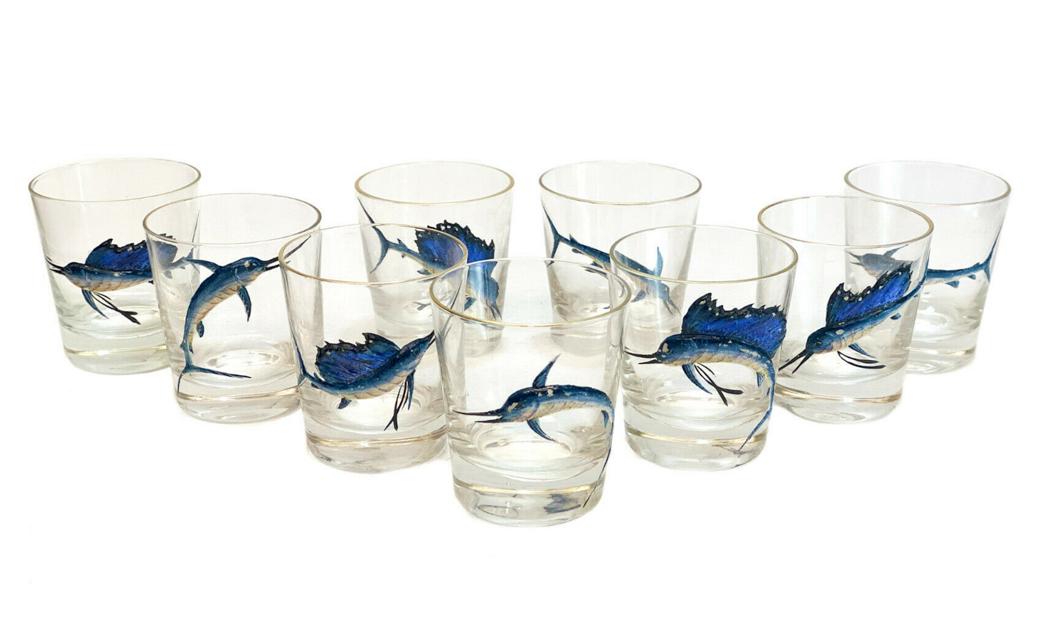 9 American Glass Enamel Swordfish Whiskey Tumblers: 9 American glass & blue hand painted raised enamel swordfish whiskey tumblers. Gilt to the top rims. Weight Approx., 8 lbs Measures Approx., 3.25 inches diameter x 3.5 inches Domestic Shipping: $50