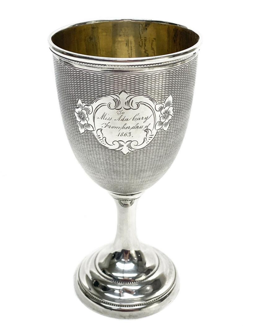 American Coin Silver Gold Wash Interior Wine Goblet: American coin silver gold wash interior wine goblet, 1863. Engine turned texture throughout the exterior of the bowl. Inscribed to the center, "To Miss Ada Cary From Her Class of 1863"Gold wash interi