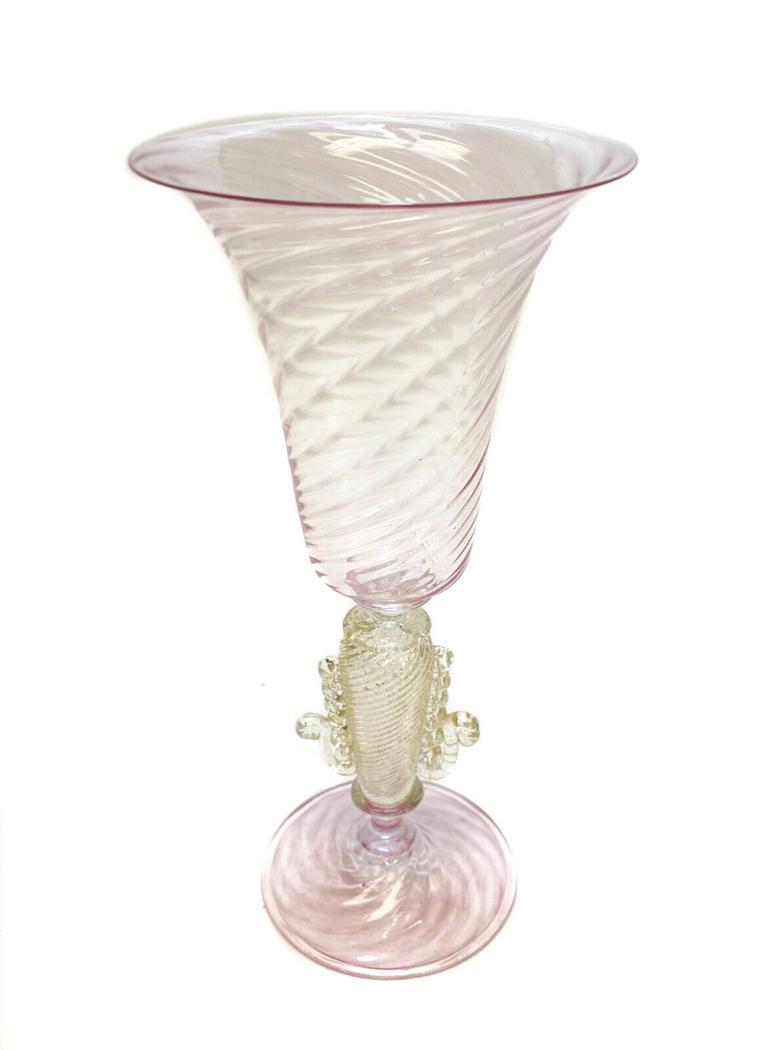 Venetian Pink Glass Gold Fleck Tall Water Goblet,: Venetian pink art glass tall water or wine goblet, Signed. A rippled texture to the bowl and base of the goblet. A rippled gold fleck stem with swirls accents. Artist signed to the base, although it i