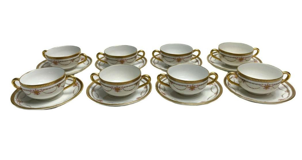 8 Bernardaud Limoges Porcelain Bouillion Cups & Saucers: 8 Bernardaud Limoges Porcelain Gilt Bouillion Tea Cups & Saucers with Floral Swags c1910. Gilt design around rim and floral swag decorations throughout. Weight Approx., 4 lbs Measures Approx., Tea cup