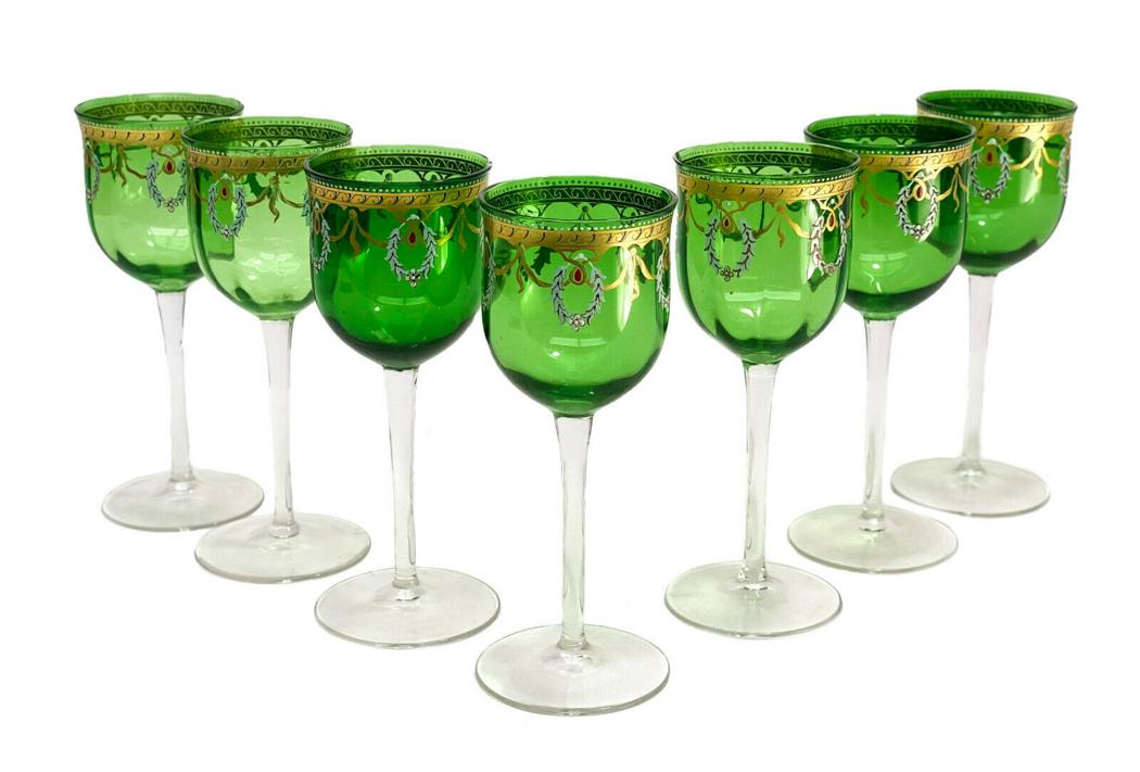 7 Venetian Emerald Green Clear Glass Enamel Wine: 7 Venetian emerald green and clear glass enamel wine goblets. Emerald green to the bowls of the goblets. Enamel wreaths with gilt laurel swags towards to the top edge. Clear to the stem and base. Weig