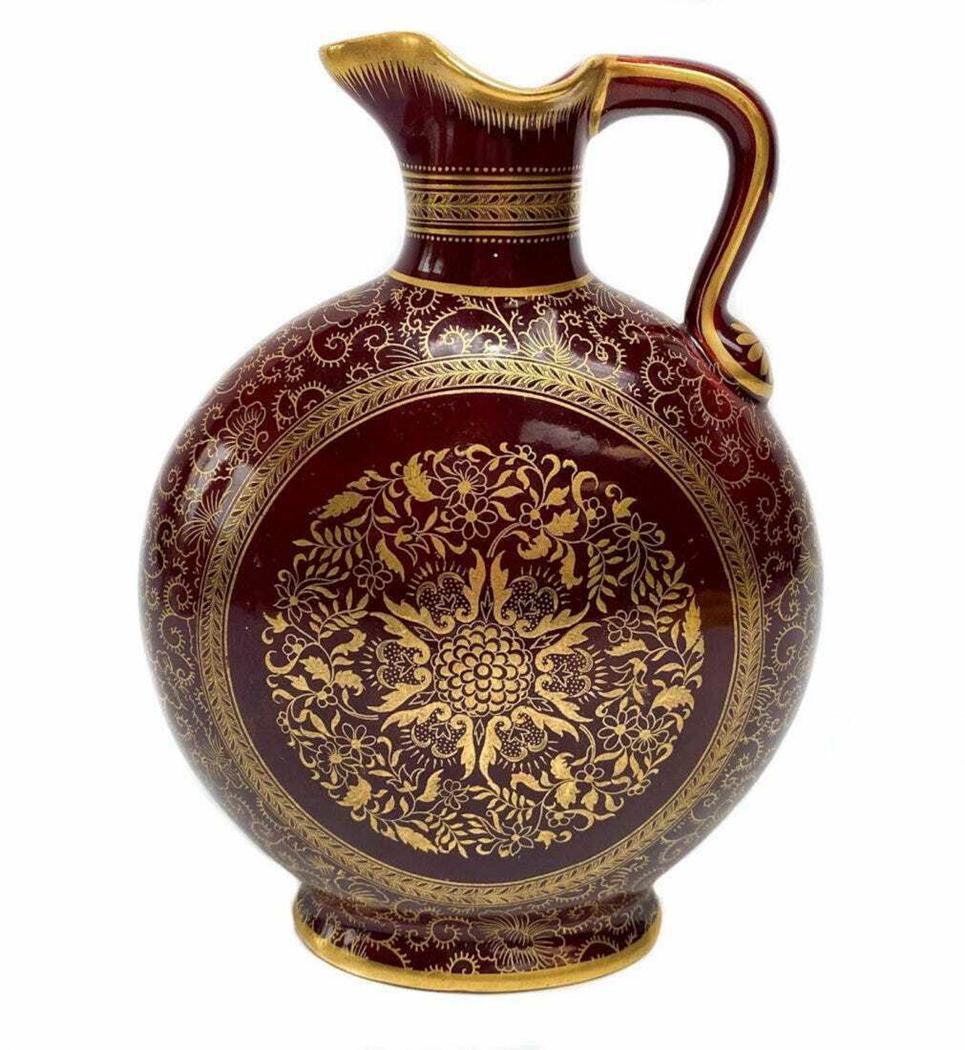 Minton Porcelain Jug Gilt Decorated: Minton Porcelain Jug, c1860. Maroon red ground with elaborate gilt decoration all over.Signed to underside.Measures: 6.8 in. x 2.9 in. x 8.7 in. tall Domestic Shipping: $35
