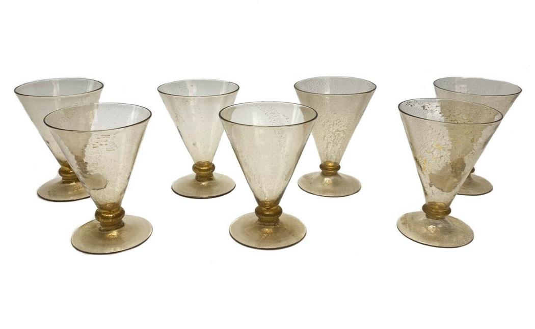 7 Venetian Gold-Flecked Midcentury Wine Glasses: 7 trumpet-shaped gold-flecked hand blown wine glasses with pontil on underside. Weight Approx., 1.3 lbs Measures Approx., 3.2 in. diameter x 4.3 in. tall. Domestic Shipping: $25