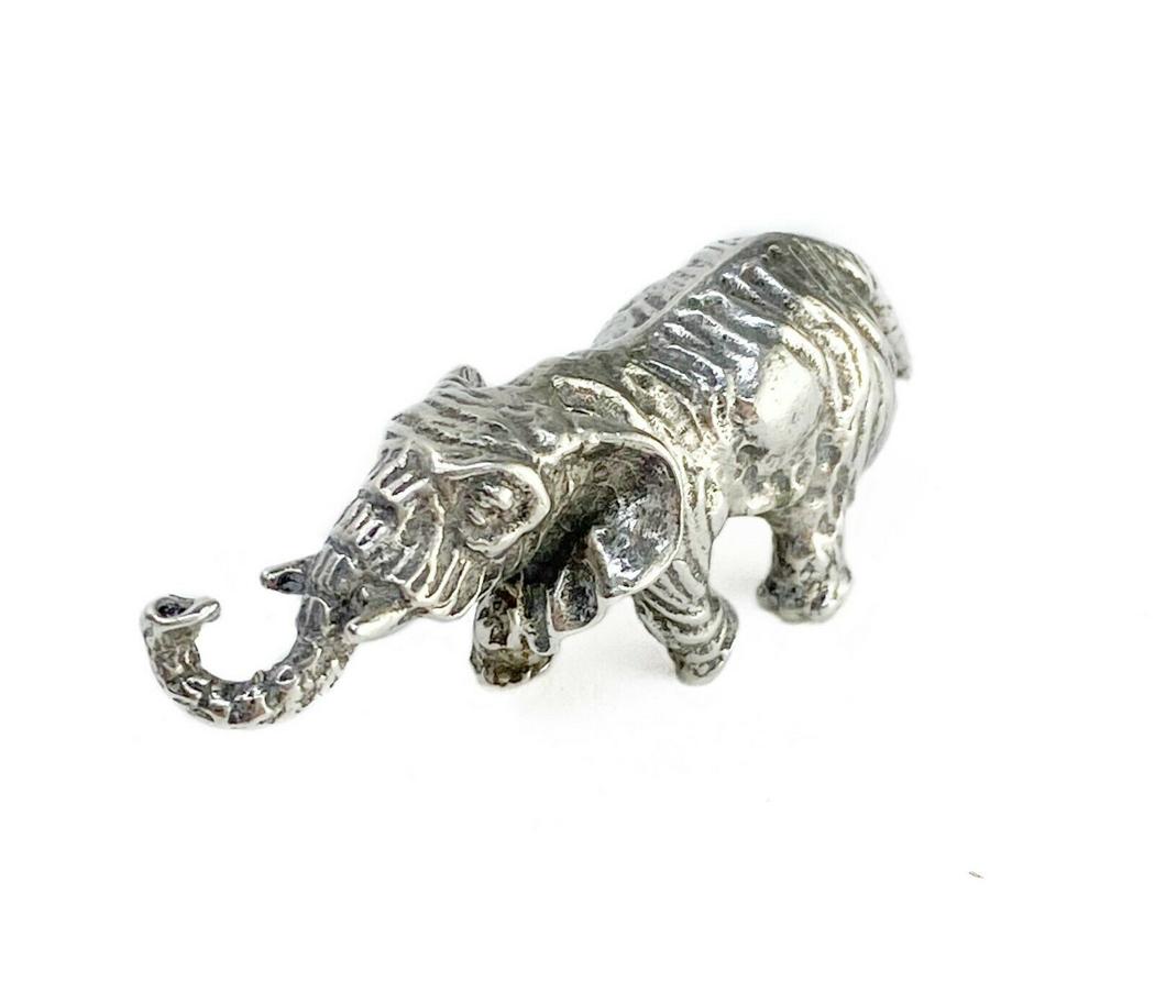 Santini Donato 800 Silver Miniature Elephant Figurine: Santini Donato Italian 800 solid silver miniature elephant figurine, circa 1970. "800" silver mark and "100AR" makers mark to underside. Weight Approx., .73 ozt Measures Approx., 2 inches x.625 inches