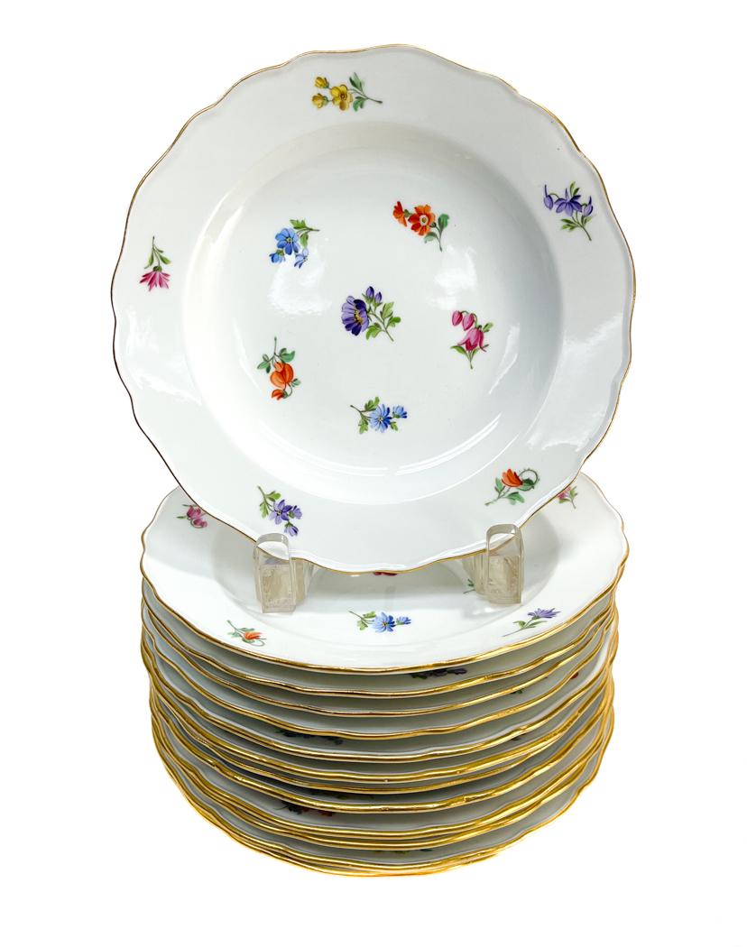 11 Meissen Germany Porcelain Scallop Rimmed Bread: 11 Meissen Germany porcelain scallop rimmed bread plates. Various hand painted scattered florals to the the plates. Scallop rimmed edge. Meissen mark to the underside. Weight Approx., 4 lbs Measures A