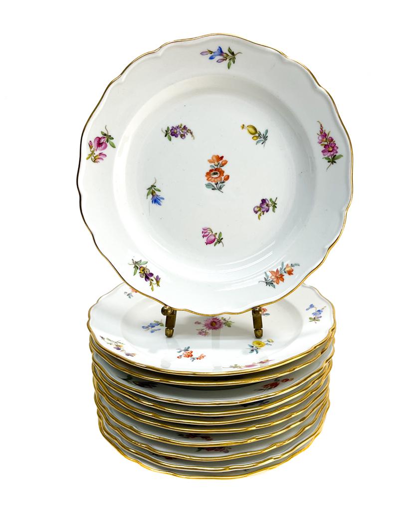 12 Meissen Germany Hand Painted Porcelain Dessert: 12 Meissen Germany porcelain scallop rimmed dessert plates. Various hand painted scattered florals to the the plates. Scallop rimmed edge. Meissen mark to the underside. Weight Approx.,8 lbs Measures 