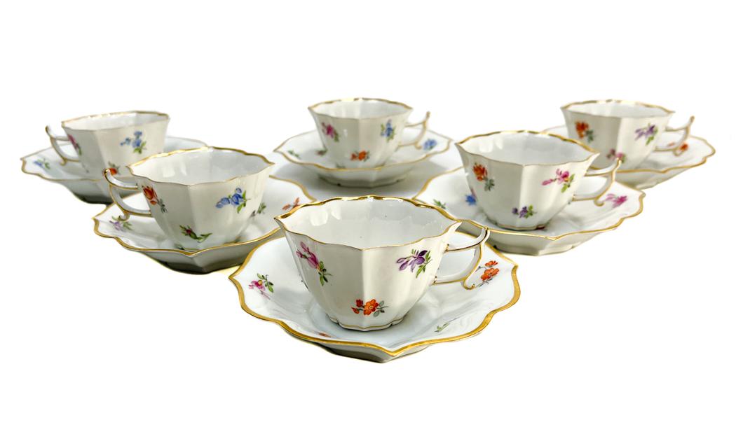 6 Meissen Germany Porcelain Cup and Saucers: 6 Meissen Germany hand painted porcelain scalloped cup and saucers. Hand painted scattered florals thoughout the exterior. Meissen mark to the underside base. Weight Approx., 1 lb Measures Approx., Cu