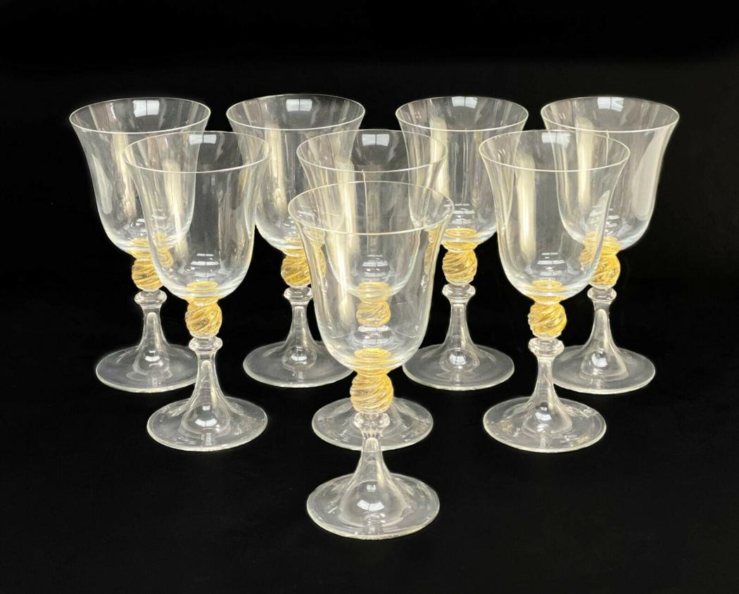 8 Venetian Glass Stemware Gold Fleck Wine Glasses: 7 Venetian Glass stemware gold fleck wine glasses. Twisted ball stem with applied gold fleck. Weight Approx., 2 lbs Measures Approx., 3.25 inches diameter x 6.5 inches tall. Domestic Shipping: $55