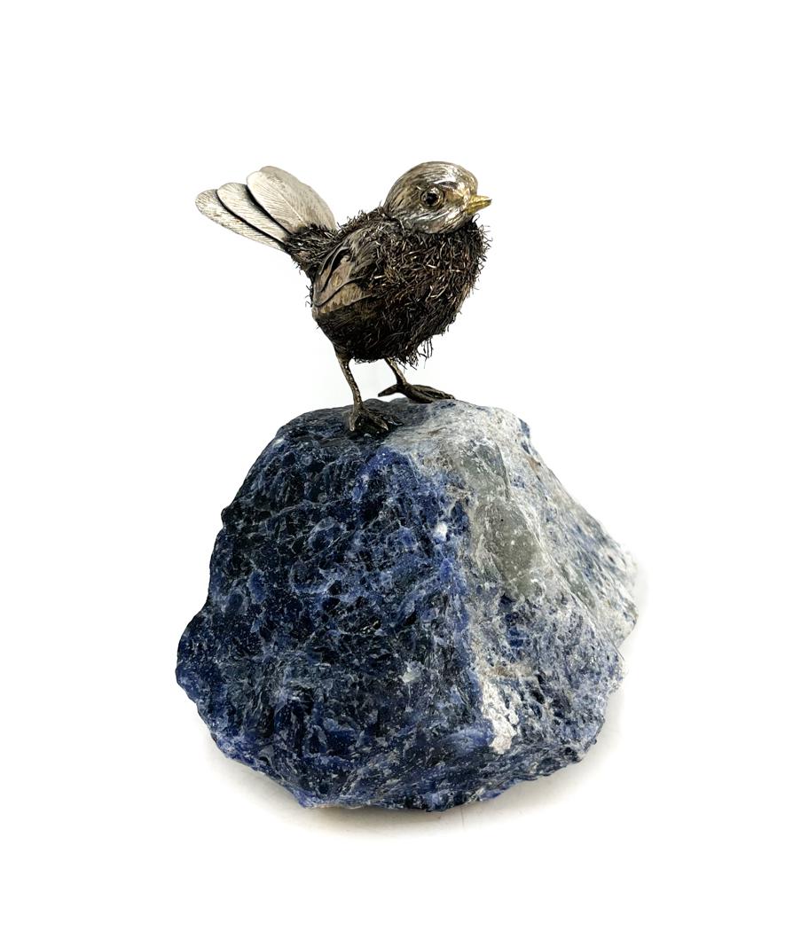 Italian Sterling Silver Bird on Sodalite Base: Italian sterling silver bird figure mounted to a sodalite base by Tegini Argenteria, 1971. Executed in the manner of Buccellati. Italian 925 sterling marks to the feather. 2nd half 20th Century. Weigh