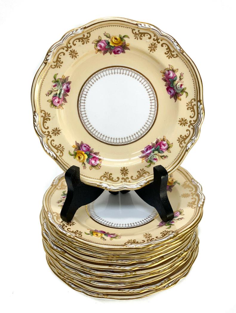 11 Copeland Spode England Porcelain Bread Plates: 11 Copeland Spode England porcelain bread plates, circa 1900. A peach ground with floral bouquets throughout. Gilt foliate scroll and floral accents. Copeland Spode England mark to the underside base.