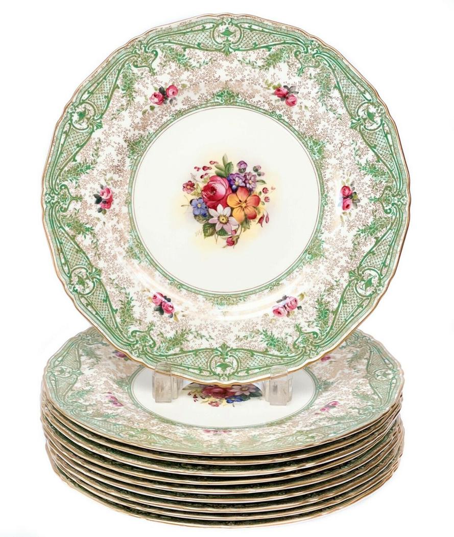 10 Royal Worcester England Porcelain 10.75 inch Dinner Plates, 1930: 10 Royal Worcester England porcelain 10.75 inch dinner plates, 1930. An off-white ground with colorful florals to the center, an ornate green foliate design to the edge. Clusters of pink roses to the 