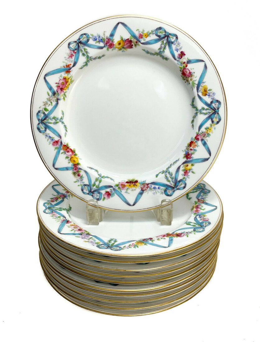 11 Royal Worcester England Porcelain Dessert Plates, 1901. Floral Garlands: 11 Royal Worcester England porcelain dessert plates, 1901. Hand painted floral garlands and ribbons to the rim with gilt edges. Royal Worcester mark to the underside base. Weight Approx., 8 lb Measure