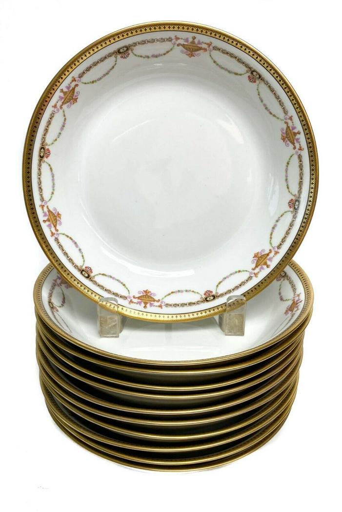 11 Bernardaud Limoges Porcelain Floral Soup Bowls: 11 Bernardaud Limoges Porcelain Gilt Rimmed Coupe Soup Bowls with Floral Swags c1910. Floral gilt swag decorations with a white ground. Weight Approx., 6.2 lbs Measures Approx., 7.4 in. diameter x 1.5