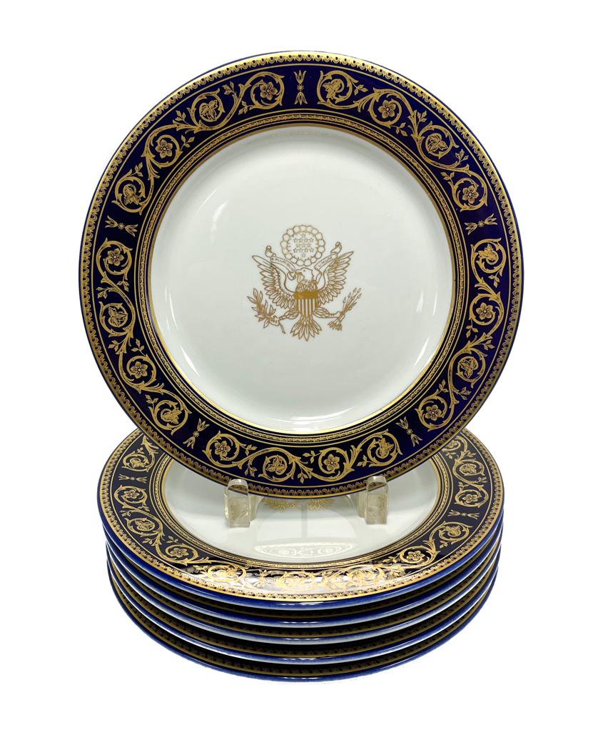6 Shenango China Porcelain Presidential Dinner Plates, Mid Century: 6 Shenango China Porcelain Presidential Dinner Plates, Mid Century . A cobalt blue ground with gilt foliate scrolls, leaves,and florals. The central emblem depicting The Great Seal of the United State