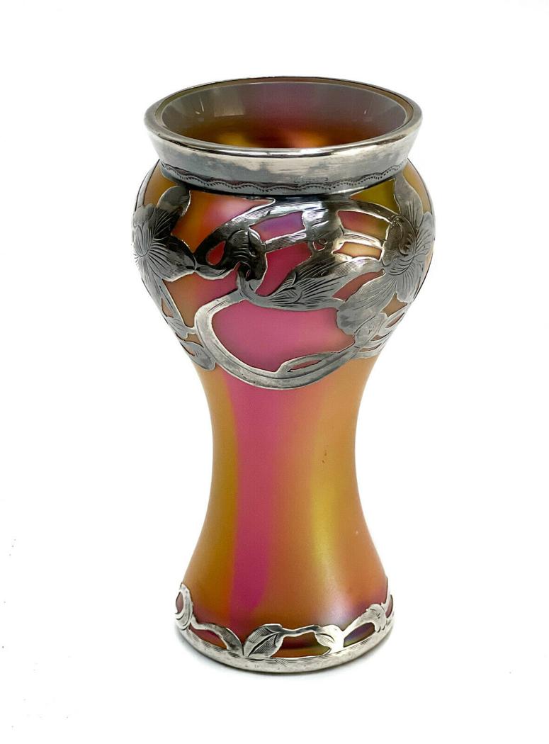 La Pierre Sterling Silver Iridescent Glass Vase: La Pierre sterling silver overlay iridescent red & yellow glass vase. Early 20th Century. Art Nouveau florals to the silver overlay. The iridescent glass attributed to Loetz. Weight Approx., 0.5 lbs M