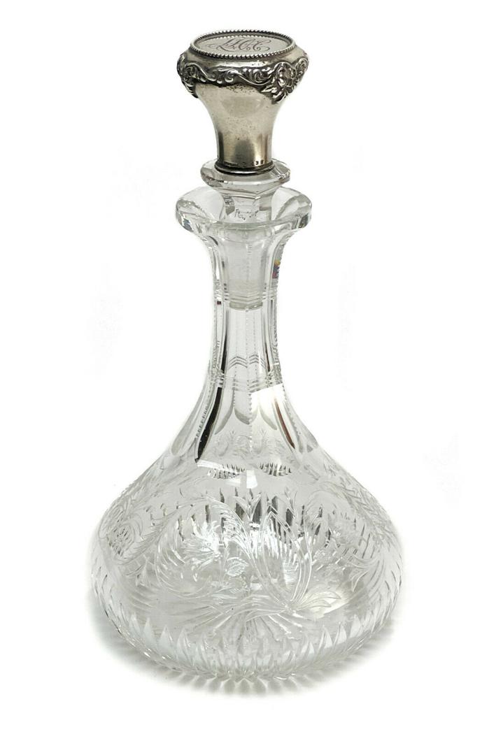 Gorham Sterling Silver and Cut Glass Decanter, 1899: Gorham sterling silver and cut glass decanter #D438, 1899. Clear cut glass foliate scrolls throughout the exterior with a starburst underside. Gorham sterling silver stopper with a 3 letter monogram t