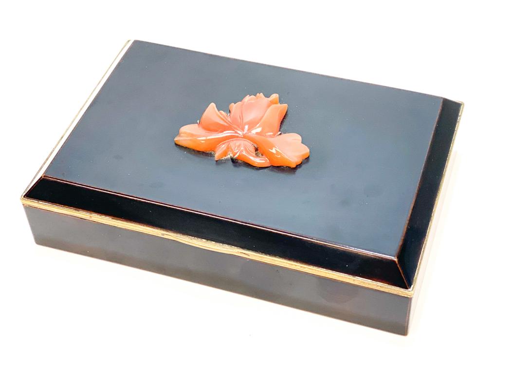 Japanese Yamanaka Box.: A Yamanaka black enamel & gilt bronze box with applied carved carnelian flower motif to the center of the box and a gilt interior. Marked to the interior. Weight Approx., 1.5 lbs Measures Approx., 5.1
