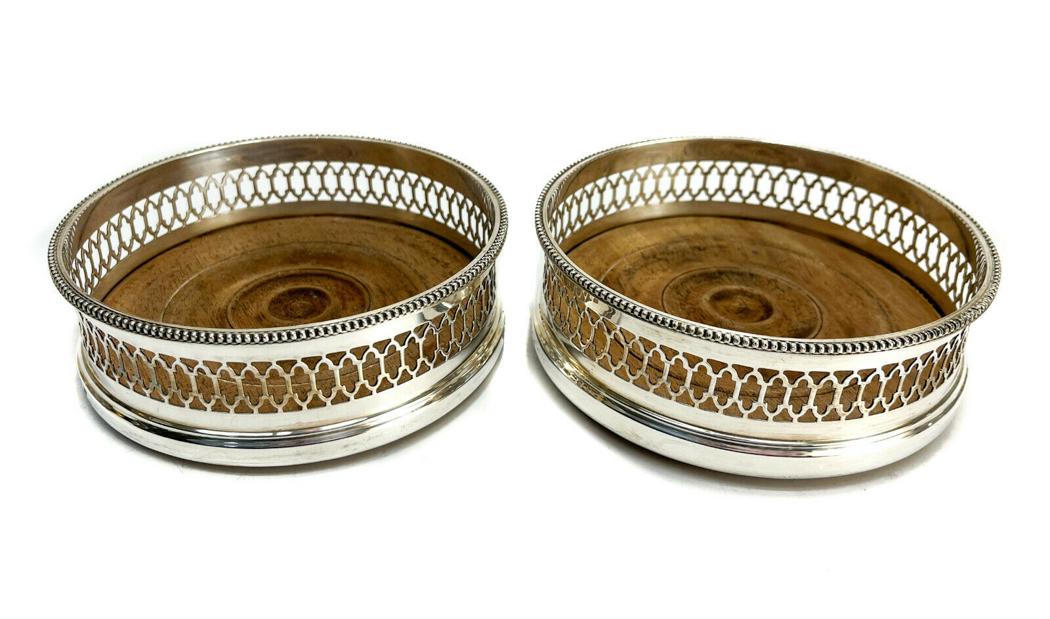 C J Vander Ltd London Sterling Silver and Wood Wine Coasters, 1978: C J Vander Ltd London sterling silver and wood wine coasters, 1978. Pierce3d design to the wall. Marked CJ Vander Ltd London mark to the base. Weight Approx., 14.27 ozt gross weight Measures Approx.,