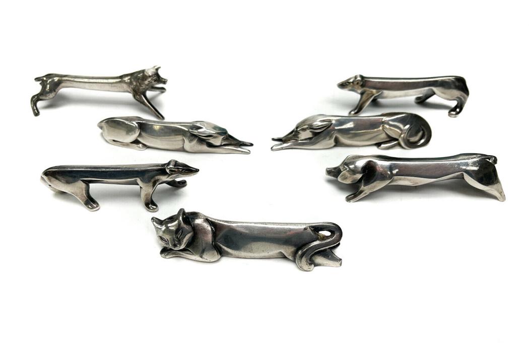 7 Christofle Gallia French Silverplate Figural Animal Knife Rests: 7 Christofle Gallia French silverplate figural animal knife rests. Various figural animals to each knife rest consisting of a cat, dog, and boar. 5 marked with the Gallia silverplate mark and 2 with n
