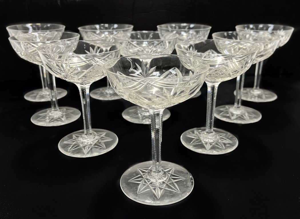 10 Val St. Lambert Clear Cut Champagne Saucers: 11 Val St. Lambert Clear Cut Wine Goblet. Cane, arch, and fan cut motifs to the bowl with ridged stems. A cut star design to the bases. Weight Approx., 1 lbs Measures Approx., 4 inches diameter x 5 in