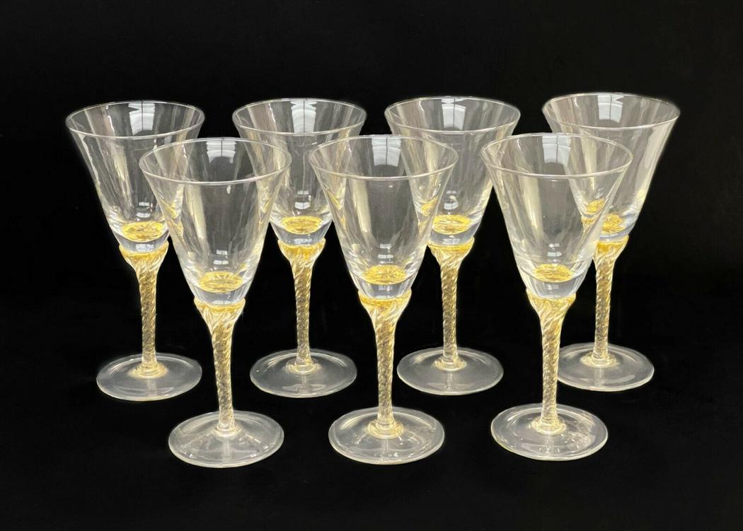 7 Venetian Glass Stemware Gold Fleck Wine Glasses: 7 Venetian Glass stemware gold fleck wine glasses. Twisted stem with applied gold fleck. Weight Approx., 2.5 lbs Measures Approx., 3.25 inches diameter x 7 inches tall. Domestic Shipping: $75