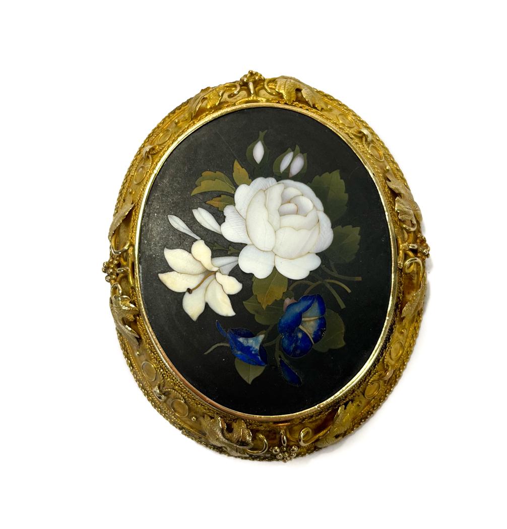 18k Gold Pietra Dura Pin Brooch: 18k Gold Pietra Dura Pin Brooch.The pietra dura depicts a bouquet of flowers consisting of a white hardstone lily and peony, and lapiz lazuli bell flowers. Elabrate grapes and leaves with a beaded tri