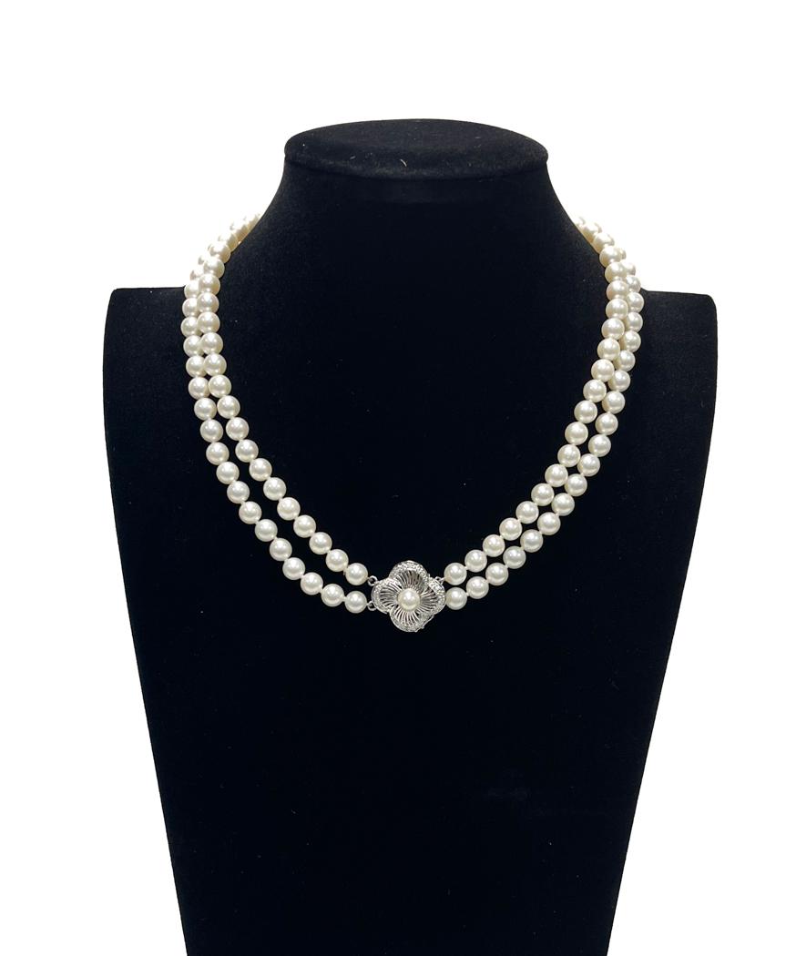 14k White Gold Diamond and 2 Strand 6.6mm Cultured Pearl Necklace: 14k White Gold Diamond and 2 Strand 6.6mm Cultured Pearl Necklace. White Gold to the filigree clasp. Marked 14k. Weight Approx., 58 grams Measures Approx., 17.5 inches length / Pearl: 6.6 mm Domestic 