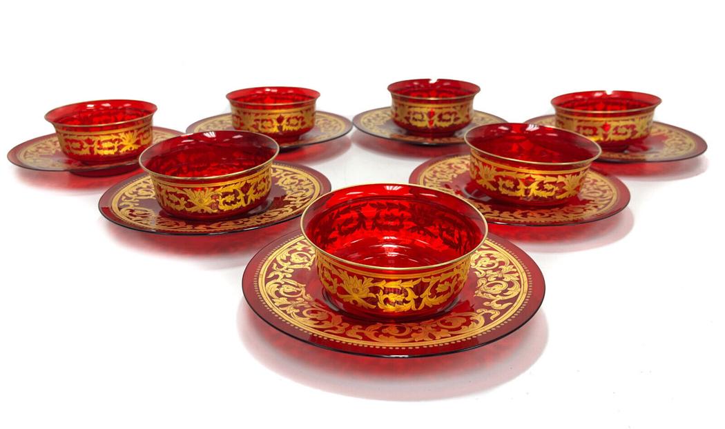 7 Venetian Cranberry Red and Gilt Art Glass Berry Bowl and Underplate, Mid Cent.: 7 Venetian cranberry red and gilt art glass berry bowls and underplates, Mid Century. Cranberry red with gilt foliate scrolls to the central area. Handblown . Pontil underside. Weight Approx., 2 lbs M