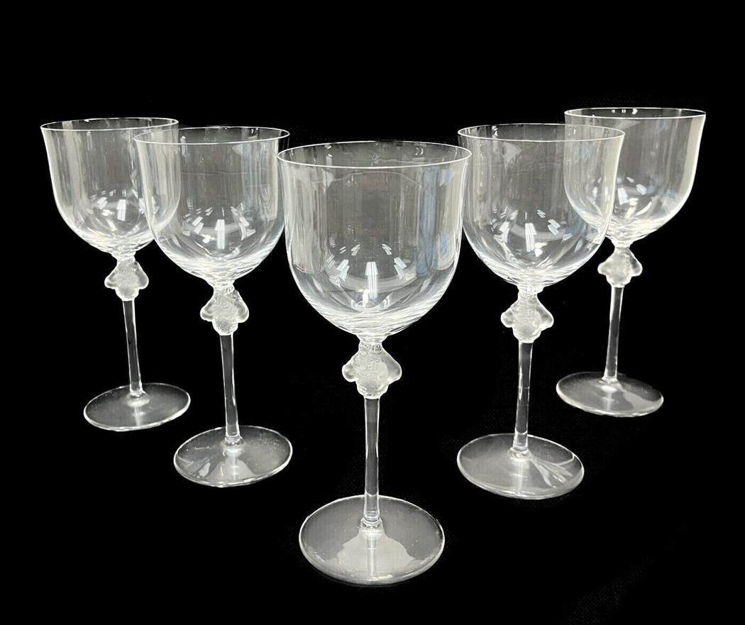 5 Lalique France Frosted & Clear Glass Water Goblet in Roxane, Signed: 5 Lalique France frosted & clear glass 12 ounce water goblets in Roxane, Signed. Each with frosted detail of two intertwined figures to the stem and scalloped beveled base. Signed Lalique to the under