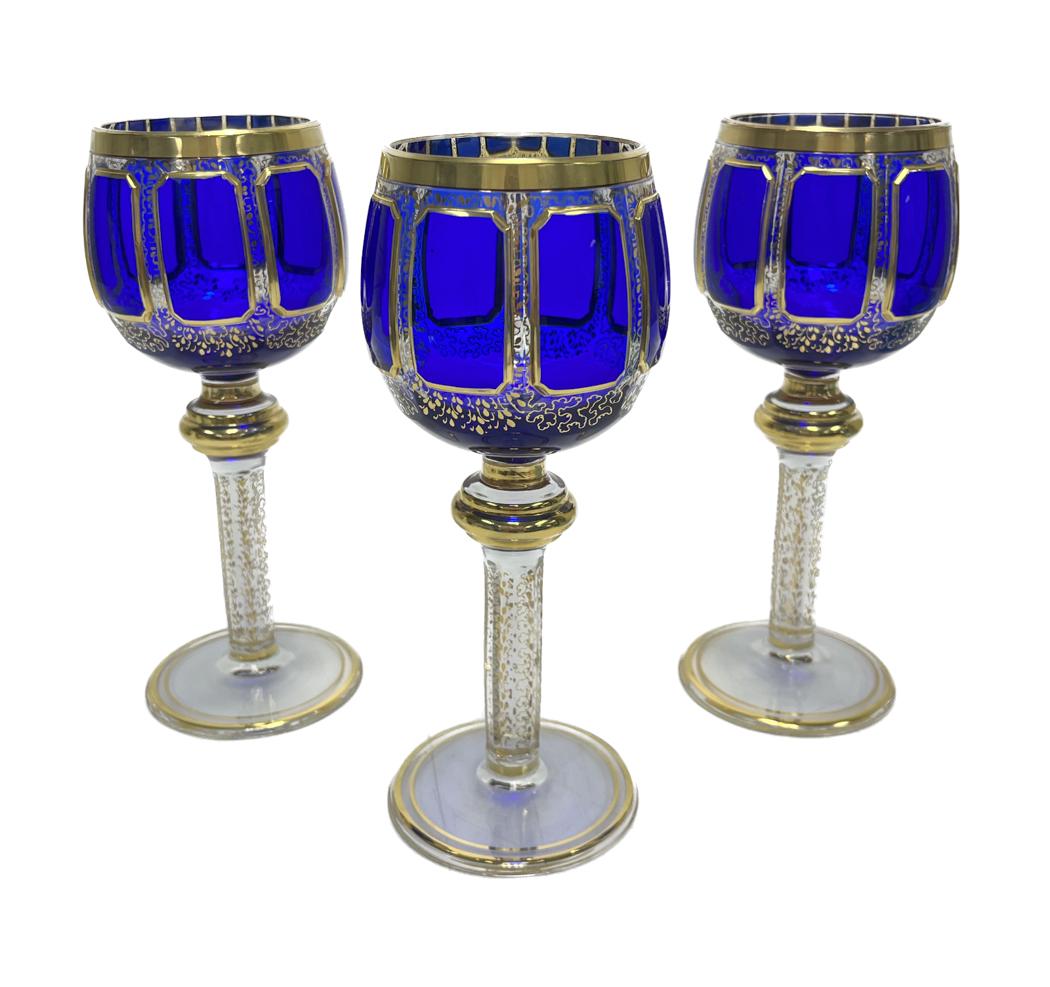3 Moser Kusak Cobalt Blue to Clear Panel Cabochon 8 ounce Wine Goblets: 3 Moser Kusak cobalt blue to clear panel cabochon 8 ounce wine glass goblets. Cobalt panels to bowl with gilt foliate scrolls throughout the body and stem. Weight Approx., 1 lbs Measures approx., 3.25