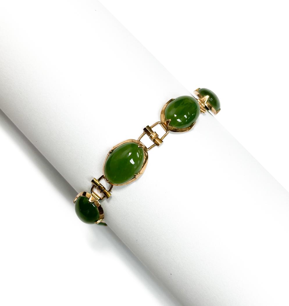 14k Yellow Gold Jade Single Strand Bracelet: 14k Yellow Gold Jade Single Strand Bracelet. 7 oval jade jewels to the strand. Marked "Taiwan 14k" to the clasp. Weight Approx., 13.21 grams Measures Approx., 7.5 inche length Domestic Shipping: $20