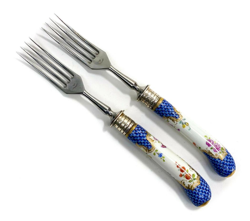 Pair Rostfrei 800 Silver Porcelain Forks: Pair Rostfrei 800 silver & Dresden or Meissen porcelain forks, Early 20th Century. A white ground with hand painted florals to the handles with blue fish scales. Marked Rostfrei to the tines and 800 t