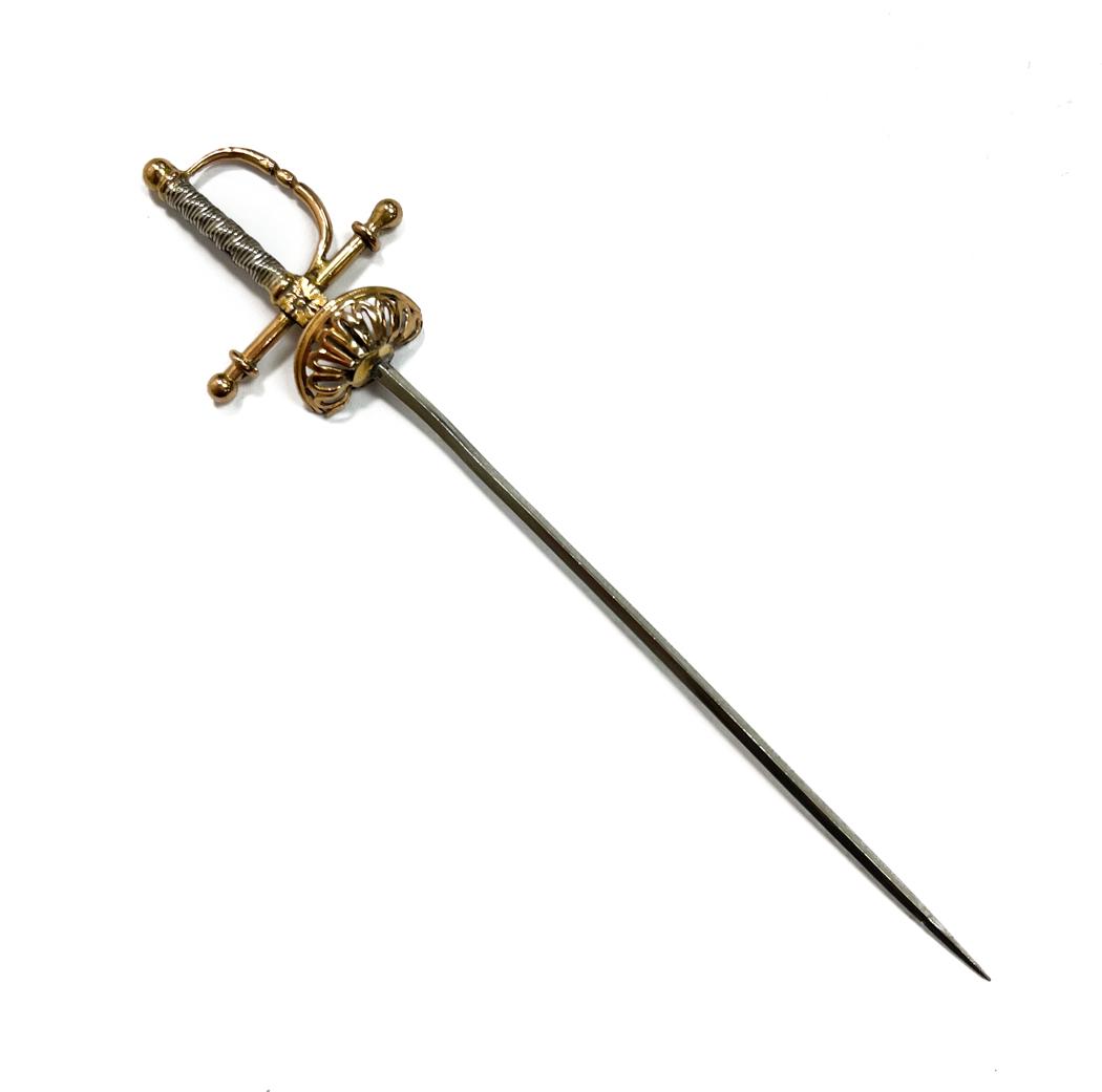 14k Rose and White Gold Sword: 14k Rose and White Gold Miniature Sword, likely to function as a lapel or hat pin. Rose Gold to the handles with 10k white gold sword. Unmarked. Weight Approx., 4 grams Measures Approx., 3.75 inches l