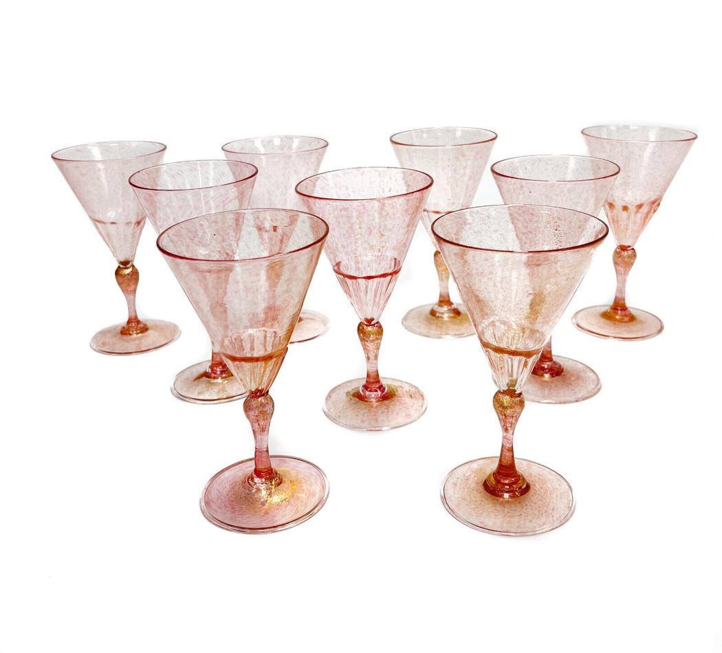 9 Venetian Cranberry Art Glass and Gold Fleck Wine Goblets: 9 Venetian cranberry art glass and gold fleck wine goblets. Partially ribbed towards the bottom of the bowl that meets the stem. Pontil to the underside base. Weight Approx., 2 lbs Measures Approx., 3