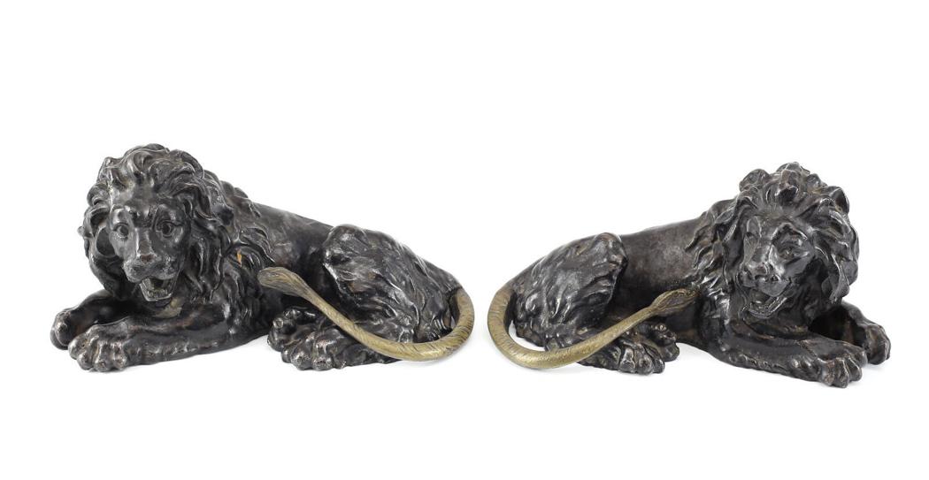 Pair of hand Painted Black Iron Lion Figurines; Posed Lying Down, 20th Century: Pair of hand painted Black Iron Lion Figurines. These Lovely Lions are laying down Posed in mid roar. The tales are in contrast to the bodies. 19th Century. Unmarked. Weight 10 pounds.Measures Approx.