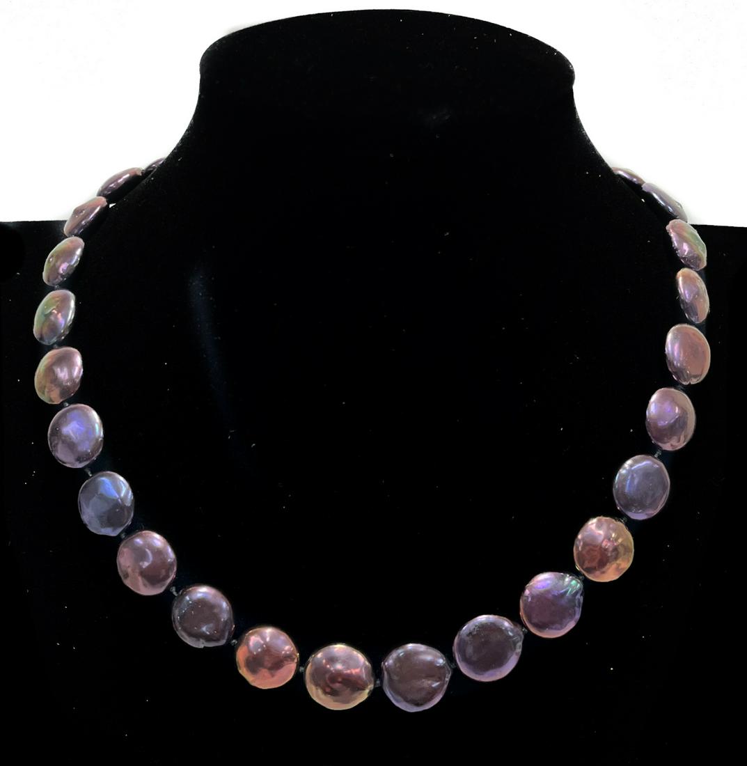 14k White Gold and Purple Coin Cultured Pearl Necklace: 14k white gold and iridescent purple coin cultured pearl single strand necklace. 29 coin cultured pearl to the strand with a white gold clasp. Marked "14k" to the clasp. With velvet dustbag. Weight Ap