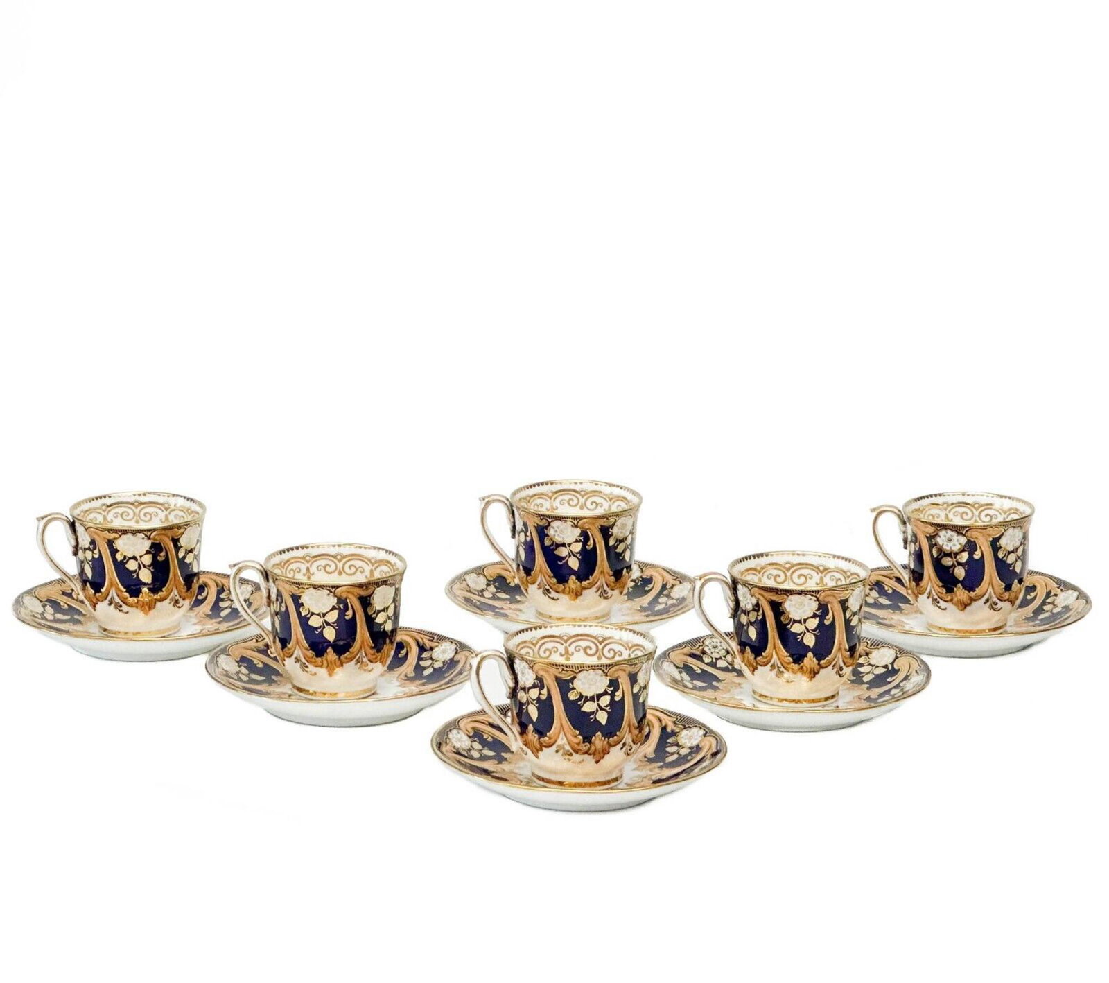 6 English Gilt & Cobalt Blue Porcelain Coffee Cups & Saucers c. 1900: 6 English porcelain coffee cups and saucers, circa 1900. A cobalt blue ground to the edge with gilt foliate decoration and snowflakes. Numbered mark to the underside. Weight Approx., 3.5 lbs Measures 