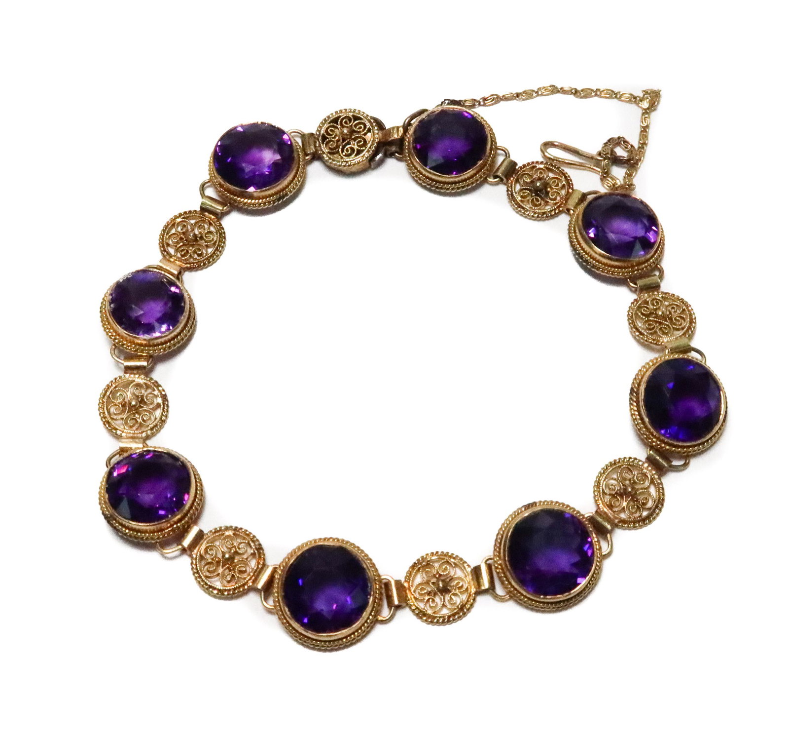 14k Yellow Gold Amethyst Round Bracelet: 14k Yellow Gold Amethyst Round Bracelet. 8 Round cut diamonds with gold filigree. Marked "14k" to the inner band. Weight Approx., 11.74 grams Domestic Shipping: 7 inches length Domestic Shipping: $35