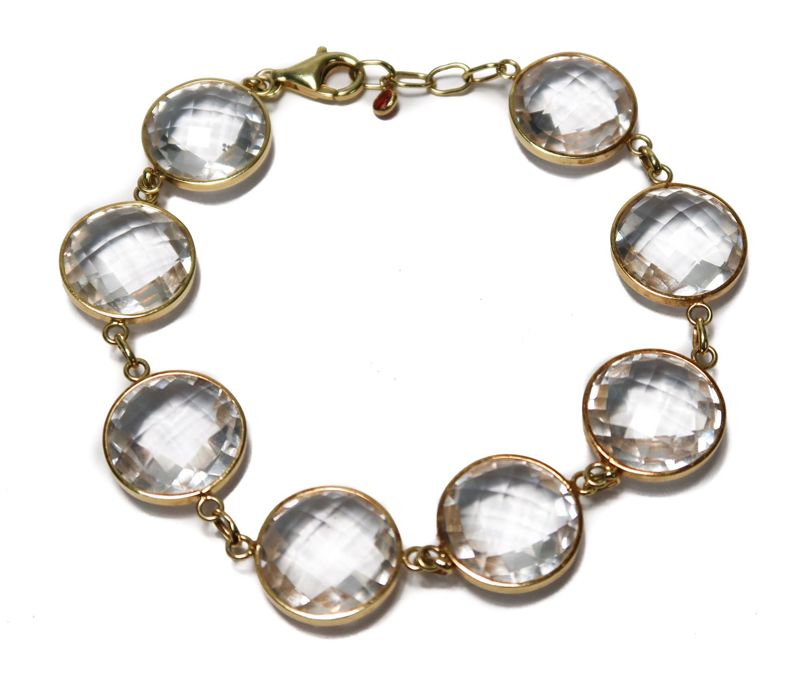 14k Yellow Gold Rock Crystal and Pink Tourmaline Bracelet: 14k Yellow Gold Rock Crystal and Pink Tourmaline Bracelet. 8 round rock crystals measuring approximately 13.9mm each. The clasp with an attached pink tourmaline jewel. Marked "14k" to clasp. Weight Ap