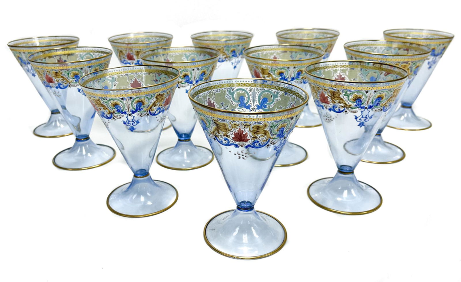 12 Salviati Blue Art Glass Hand Painted 9 ounce Water Goblets, 2nd quarter 20th century: 12 Salviati Venetian blue art glass hand painted 9 ounce water goblets, 2nd quarter 20th century . Periwinkle blue glass with hand painted foliate scrolls and leaves to upper rim. Pontil underside. We