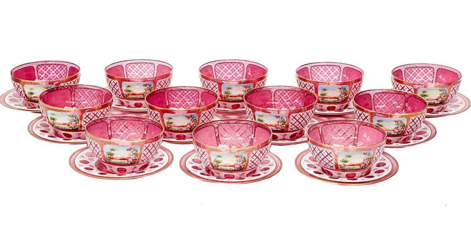 12 Moser Enameled Pink Glass Cut to Clear Fruit or Dessert Bowls & Underplates: 12 enameled pink glass cut to clear fruit or dessert bowls and underplates, circa 1930. Pink glass with enameled decoration with floral decoration, bowls with panels of painted landscape scenes, gilt 
