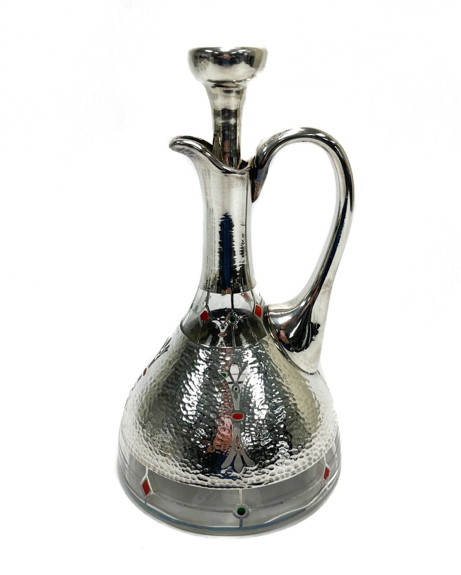 American Art Deco Hand Hammered Silver Overlay Enamel Ewer, circa 1920: 6 American Art Deco hand hammered silver overlay enamel ewer or carafe, circa 1920. Hand hammered with red and green enamel decoration. Acid etched Rockwell to the underside base. Weight Approx., 6 lb